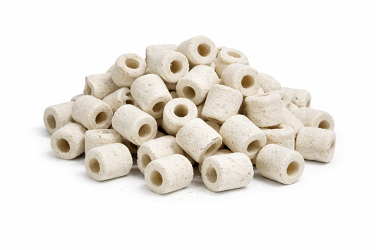 White cylindrical ceramic beads on a white background