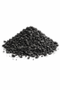 Pile of black granular carbonon a white background