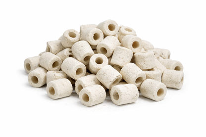 White cylindrical ceramic beads on a white background